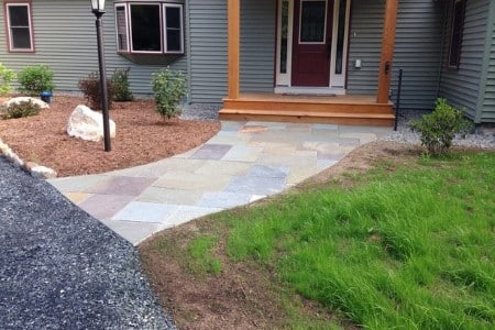 A natural stone walkway installed by JCB Designscapes at a Newport area home