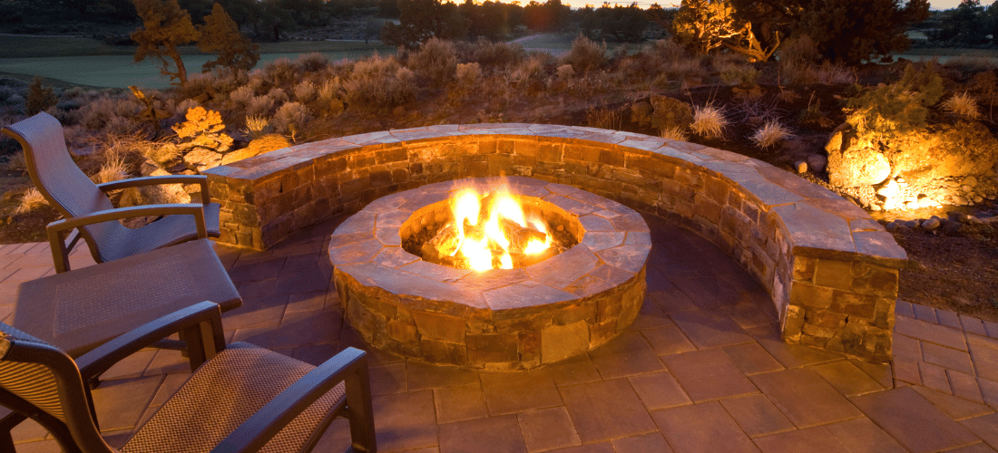 a built in fire pit against the setting sun